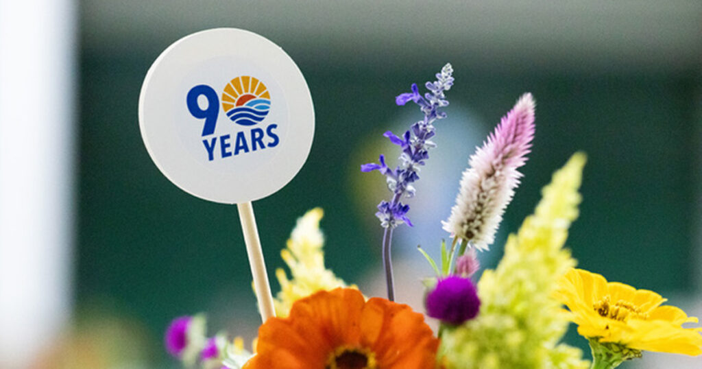 90th anniversary logo design for United Way of Greater Kingsport, featuring the commemorative anniversary mark displayed in a floral centerpiece.