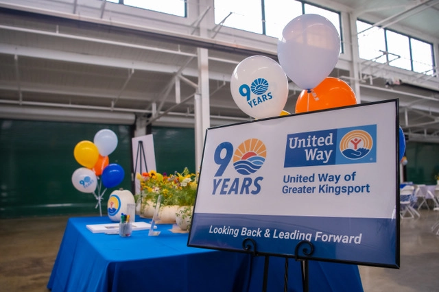 Event signage featuring the 90th anniversary logo for United Way of Greater Kingsport at the organization's anniversary celebration.