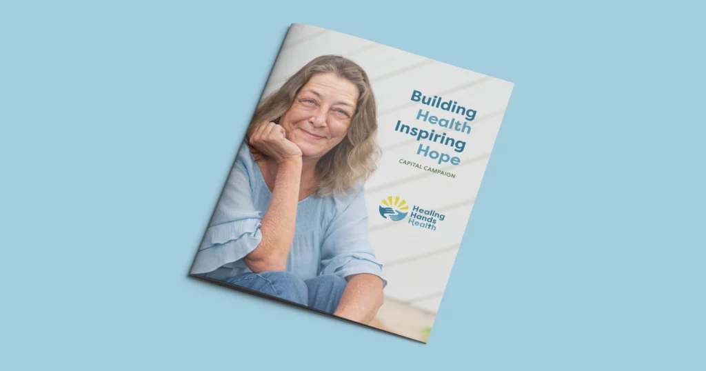 A mockup of the Healing Hands Health Case for Support is on a light blue background. A smiling middle aged white woman with the title Building Health Inspiring Hope with the Healing Hands Health logo below it.